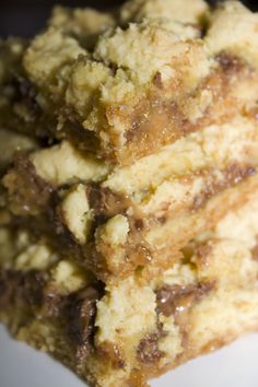 two pieces of chocolate chip cake sitting on top of each other in a white plate