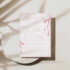 a pink and white wedding stationery on a plate with shadow from the wall behind it