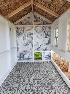 the inside of a room with floral wallpaper and flooring on it's walls