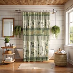 a bath room with a toilet a sink and a shower curtain covered in plants next to a window