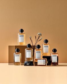 an assortment of perfume bottles sitting on top of a table