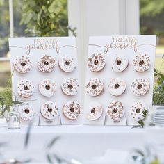 two cards with donuts on them sitting next to each other at a wedding reception