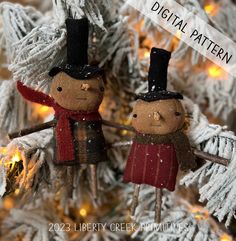 two wooden dolls are hanging from a christmas tree with lights in the background and text overlay that reads digital pattern