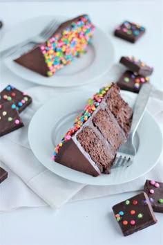 a piece of chocolate cake with sprinkles on it and a fork in the middle