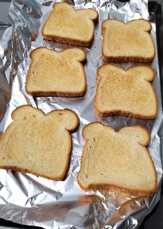 four pieces of toast sitting on top of aluminum foil