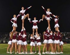 a group of cheerleaders standing on top of each other