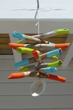 a wind chime made out of colored sticks