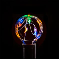 a colorful light up ball sitting on top of a black table