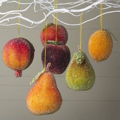 fruit hanging from strings with icing on them