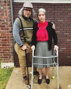 a man and woman standing next to each other with crutches on their legs