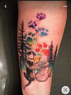 a tattoo on the leg of a person with a dog and trees in the background