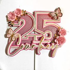 a pink cake topper with flowers and butterflies on it's number twenty five