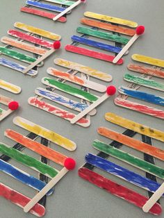 popsicles made out of toothpicks are sitting on a table with pins stuck to them