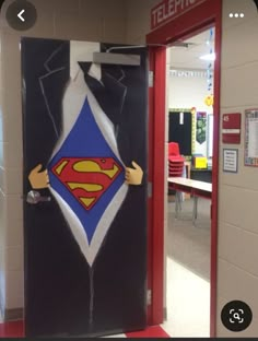 an open door with a superman symbol on it in a school hallway that is decorated to look like a telephone booth