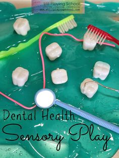 toothbrushes and toothpaste on a green plate with the words dental health sensory play