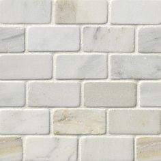 a white brick wall that is very close to the ground