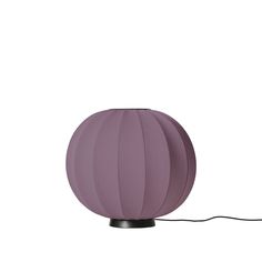 a purple lamp on a white background