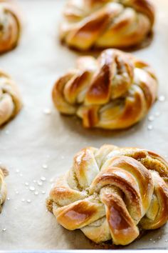 freshly baked braided breads on a baking sheet