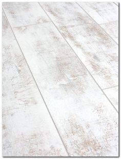 an old white wood floor with peeling paint