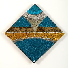 a blue, yellow and brown square shaped artwork on a white wall