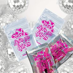 three bags of lip glosses are shown in front of disco balls