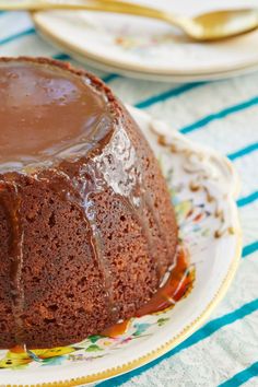 a chocolate bundt cake on a plate with caramel drizzle