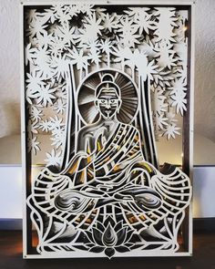 an intricate paper cut artwork depicting the buddha