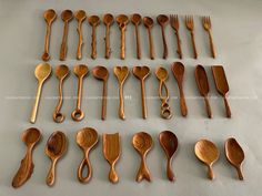 wooden spoons and forks laid out on a table