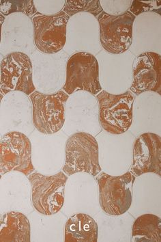 an orange and white tile pattern with the word cle on it's side