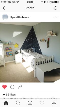 the bedroom is decorated in white and has a black triangle on the wall above it