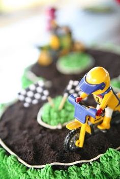 a close up of a cake decorated like a person riding a bike