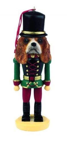 a christmas ornament with a dog wearing a hat and green uniform on it's head