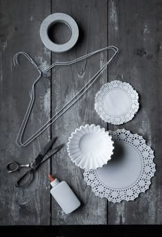 white doily and other crafting supplies laid out on a wooden table