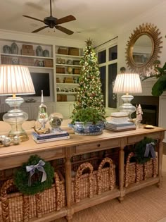 a living room with a christmas tree in the corner and baskets on the floor next to it