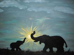 an elephant and its baby are silhouetted against the backdrop of a sunburst