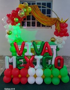 balloons and streamers are arranged in the shape of letters that spell out'avocado '