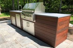 an outdoor kitchen with grill and sink