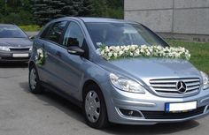 a silver car with flowers on the hood