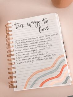 an open notebook with the words ten ways to love written in cursive writing