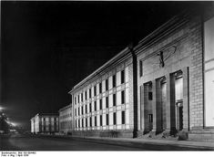 an old photo of a building at night