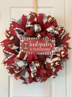 a red and white football wreath with the words tailgates and oudhowns on it