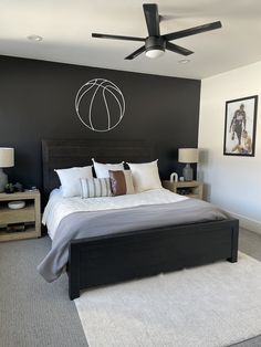 a bedroom with black walls and white carpet