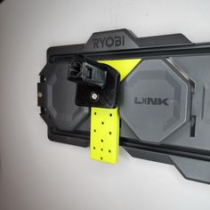 a yellow and black device attached to a wall