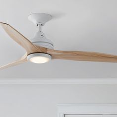 a white ceiling fan with wooden blades and light on it's blade is hanging from the ceiling