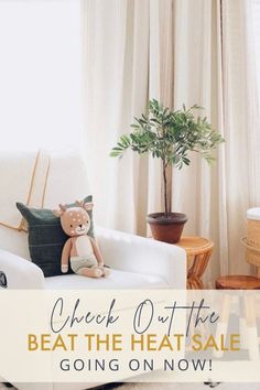 a teddy bear sitting on top of a white chair next to a potted plant