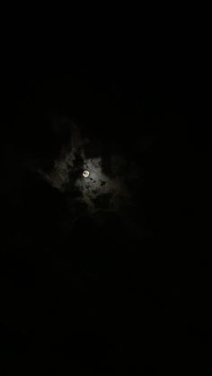 the moon is shining brightly in the dark sky