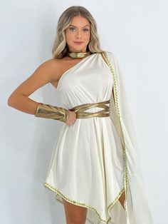 a woman in a white and gold greek dress with her hands on her hips, posing for the camera