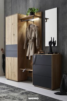 an open wardrobe with clothes hanging on it