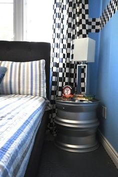 a bed room with a neatly made bed and checkered curtains