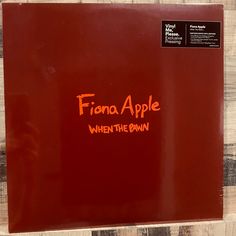 the back side of a red vinyl album with an orange writing on it that reads, fiana apple when the dawn